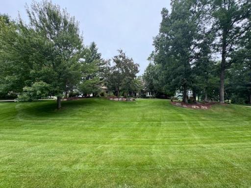 Check out the green grass, beautiful perennial gardens, tree filled yard and more!