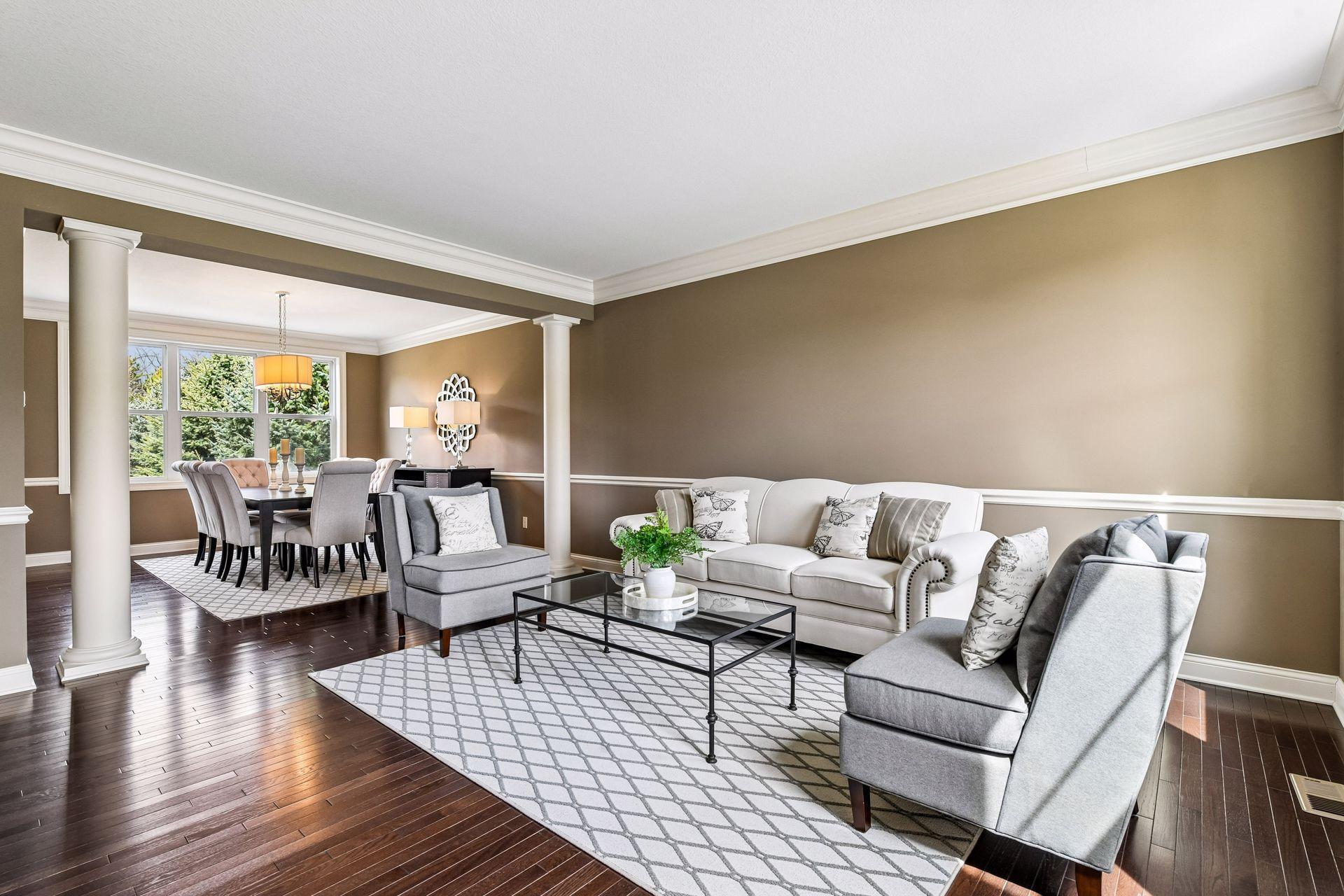 Light-filled formal living room with rich hardwood floors and classic architectural detail.