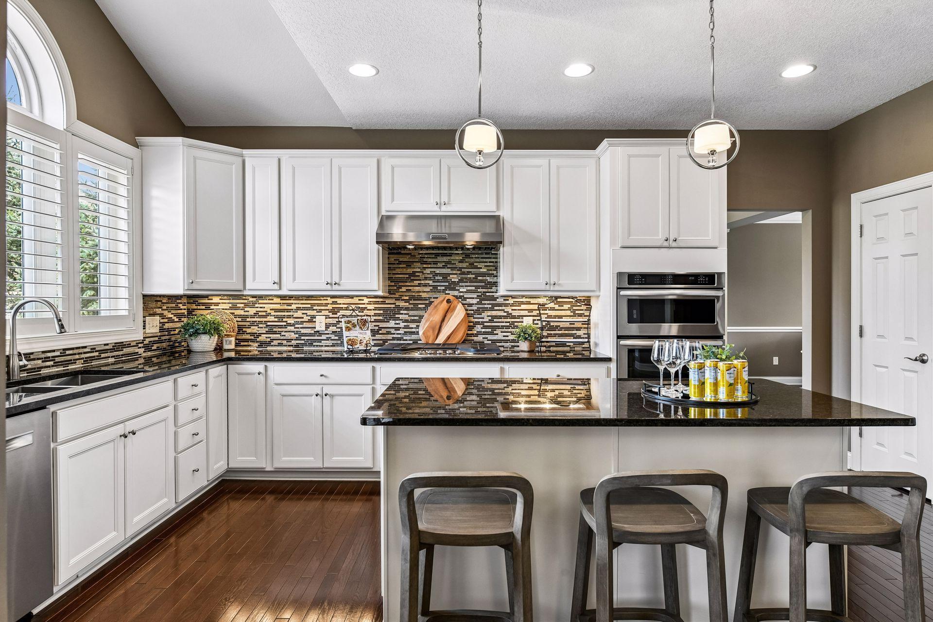 Beautifully designed chef's kitchen with oversized center island, abundant cabinetry, and stylish finishes.