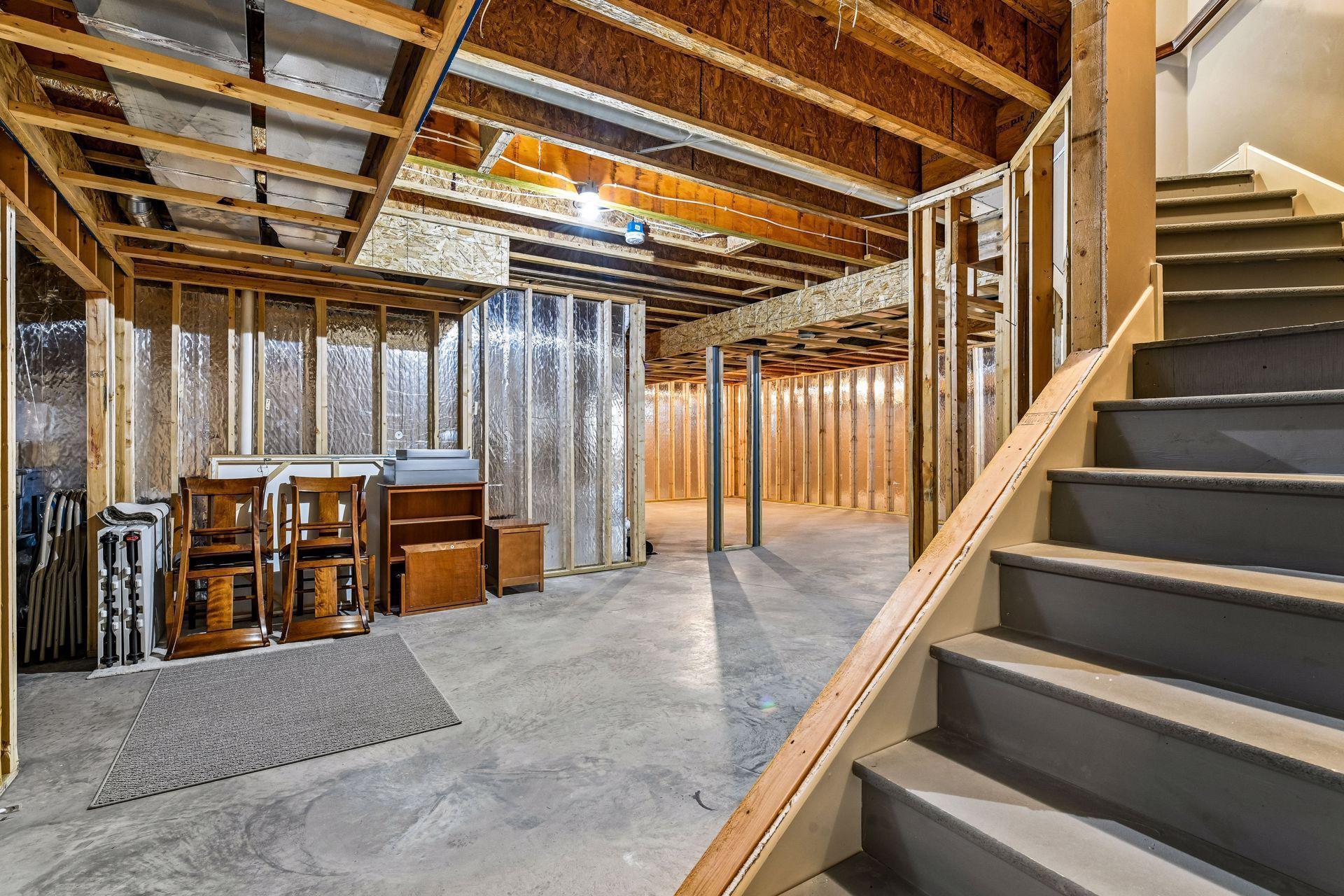 Unfinished lower level ready for future expansion.