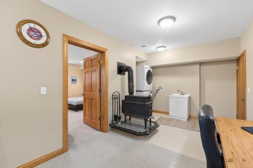 The lower level also features a wood burning stove. Perfect for those chilly evenings. Laundry area has a sink along with a stackable washer and gas dryer.