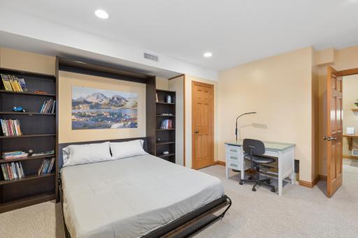 View of the space being used as a bedroom. Just outside this room the laundry with a sink.