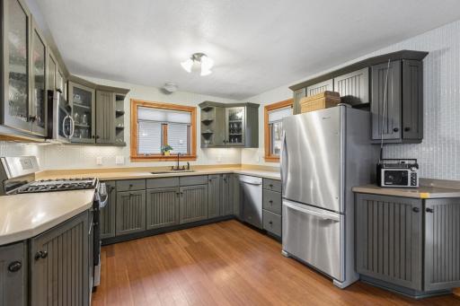 This kitchen features a gas range, stainless steel appliances and beautiful countertops.