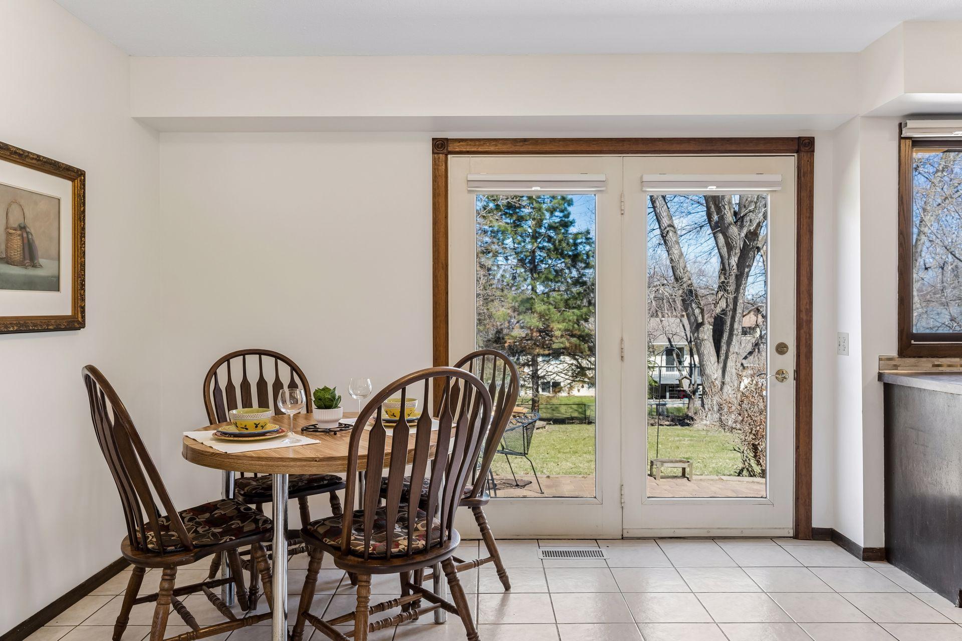 Dining area with large glass door leading to backyard, providing great indoor-outdoor flow for entertaining and daily use.