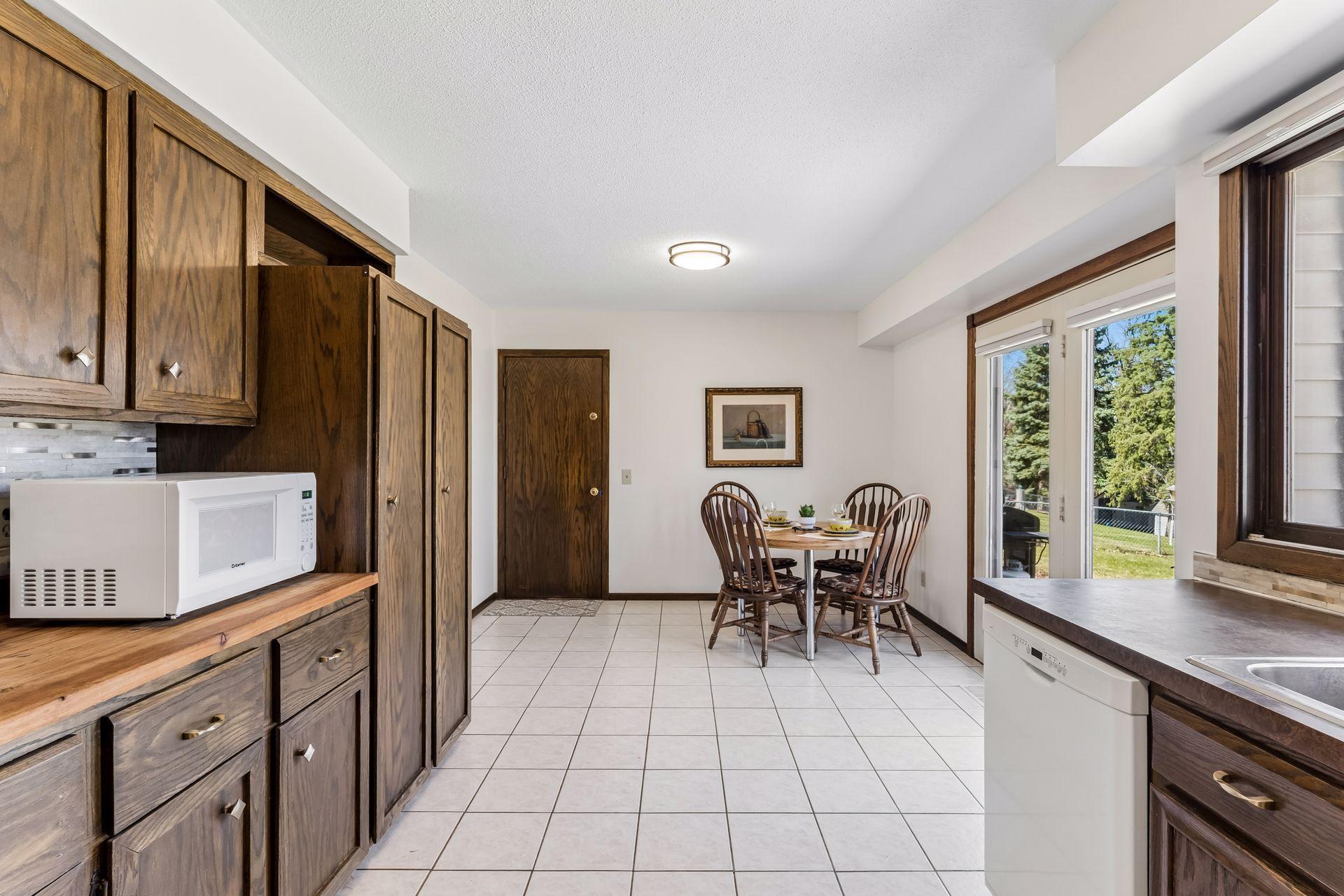 Additional kitchen view showcasing cabinetry, pantry storage, and convenient access to the garage, offering functional workspace for everyday living.