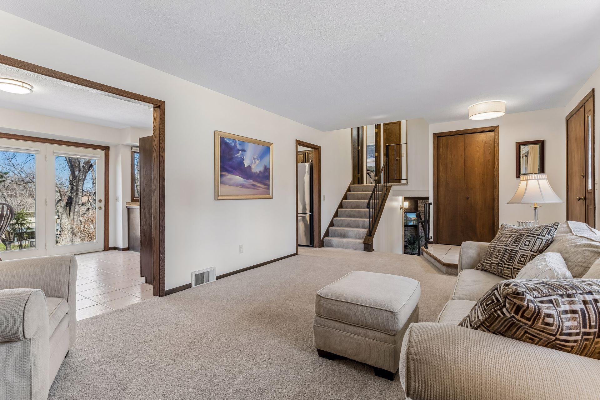 Additional view of living room highlighting natural light, fresh finishes, and seamless flow to entry and upper-level areas. Split-level home design offering efficient layout with easy access to living spaces, bedrooms, and lower-level areas.