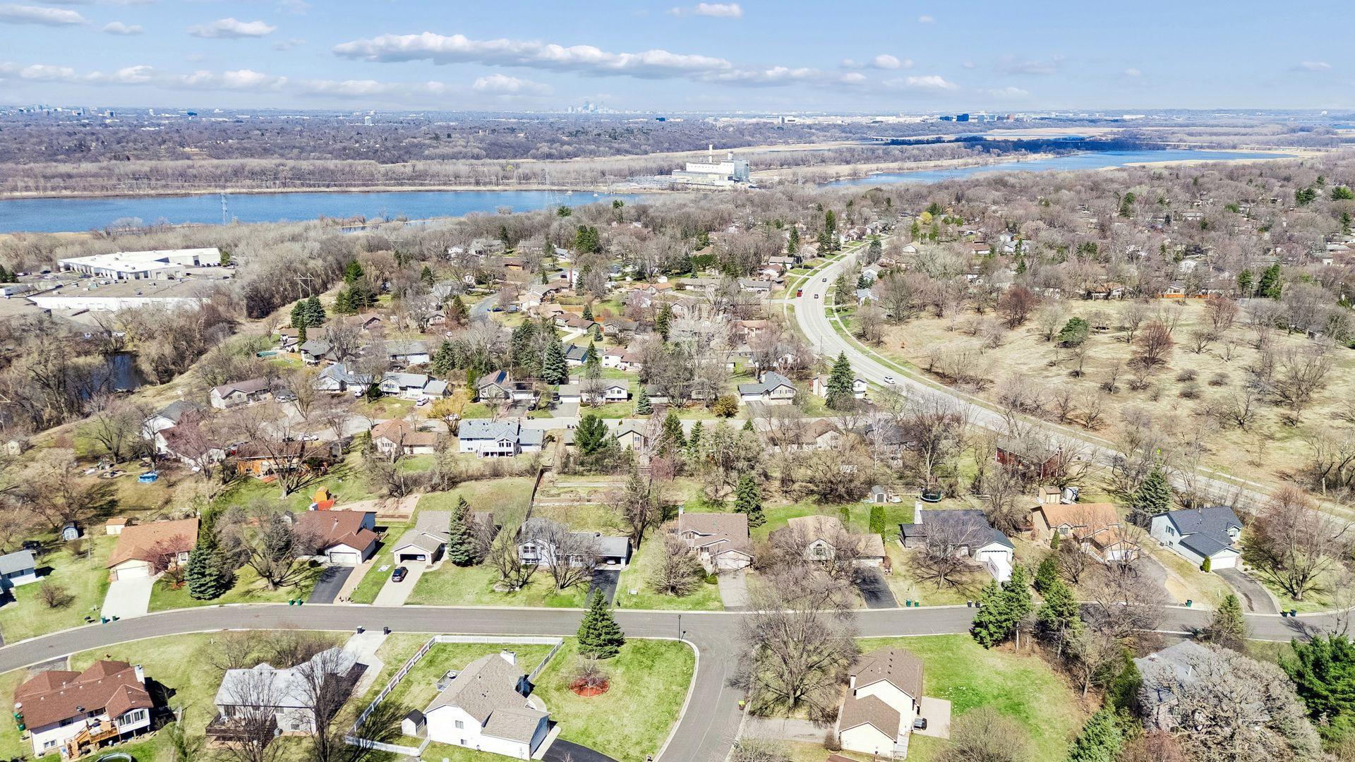 Aerial neighborhood view showcasing proximity to nearby parks, green space, the Minnesota River, and the Minnesota Valley National Wildlife Refuge, offering scenic views and access to trails and outdoor recreation.