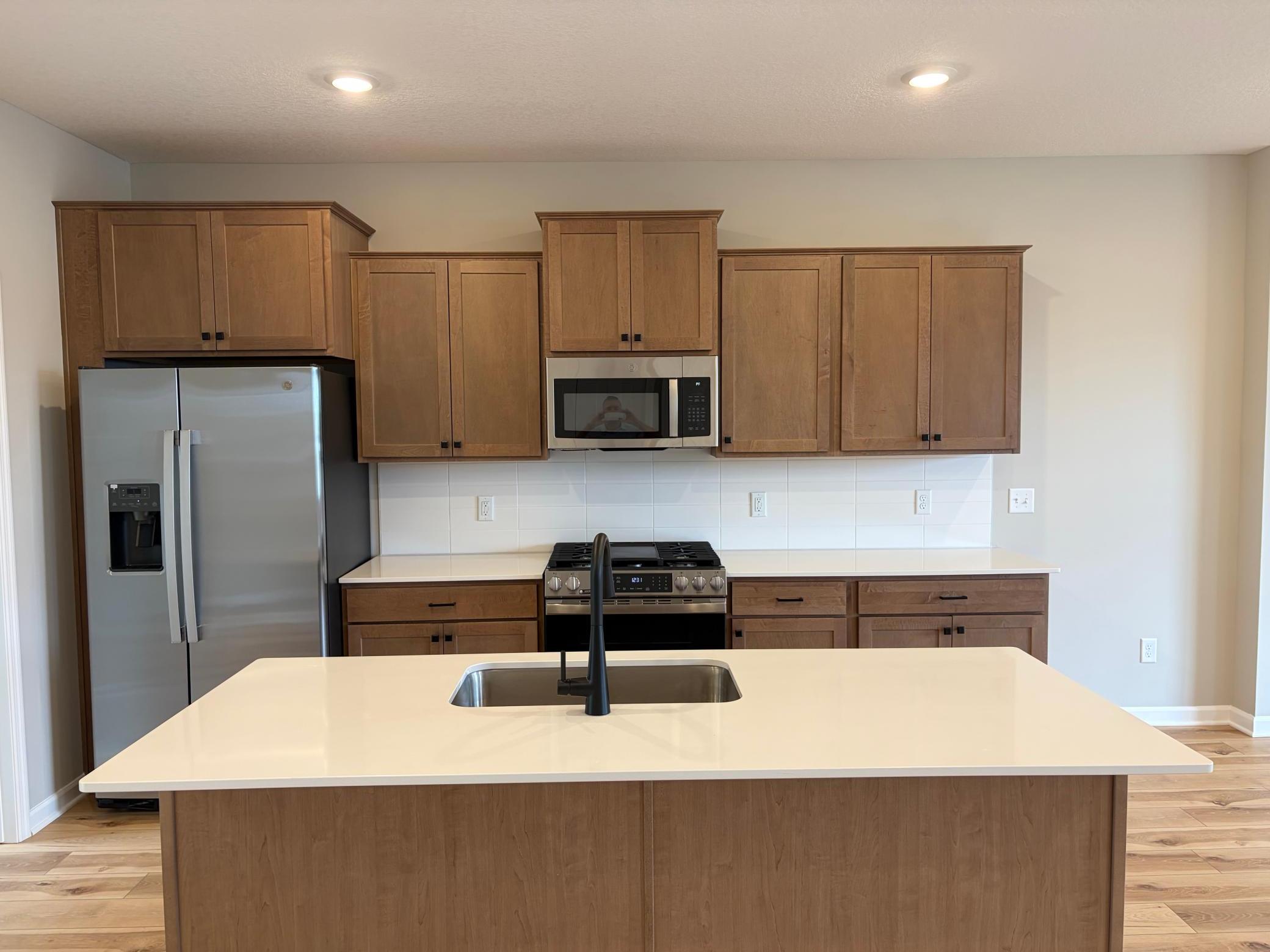 Welcome to the Afton! This home’s kitchen features an oversized island and all the kitchen appliances. With plenty of seating for those on the go for the early mornings!