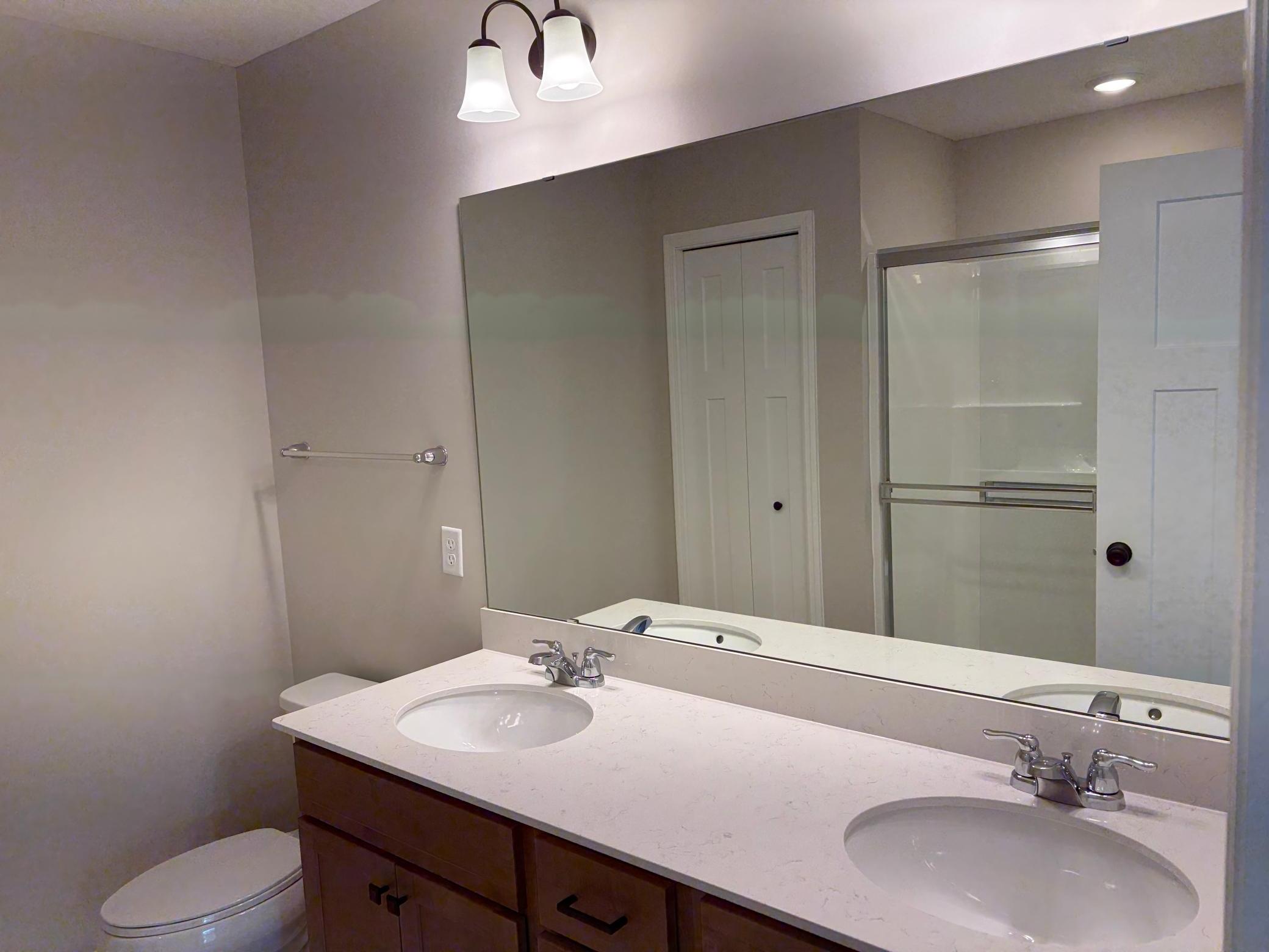 Dual vanity in the private en-suite bath provides maximum functionality. Features a large shower.