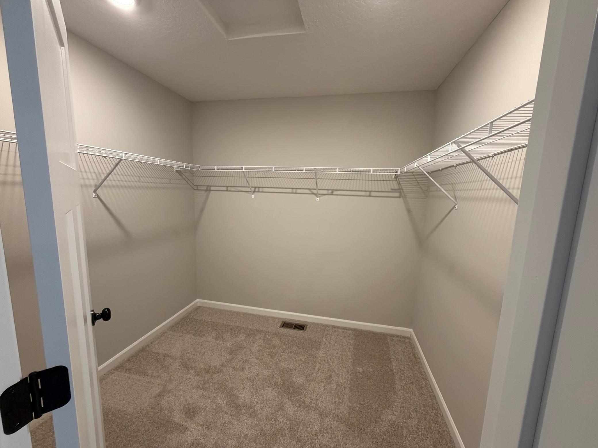 Walk-in closet with plenty of room for a dresser to keep your clothing organized.