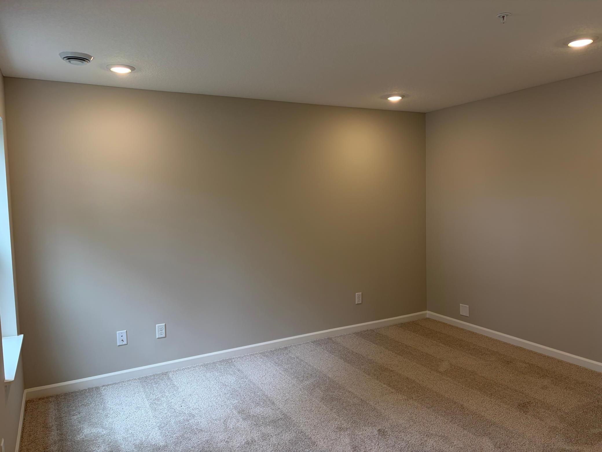 At the entry of the home, we have a spacious rec. space that is great, as a secondary living area, office, or even a makeshift 4th bedroom when you need added space!