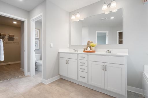 Primary bathroom with 2 sinks, Quartz counters and 2 walk in closets.
