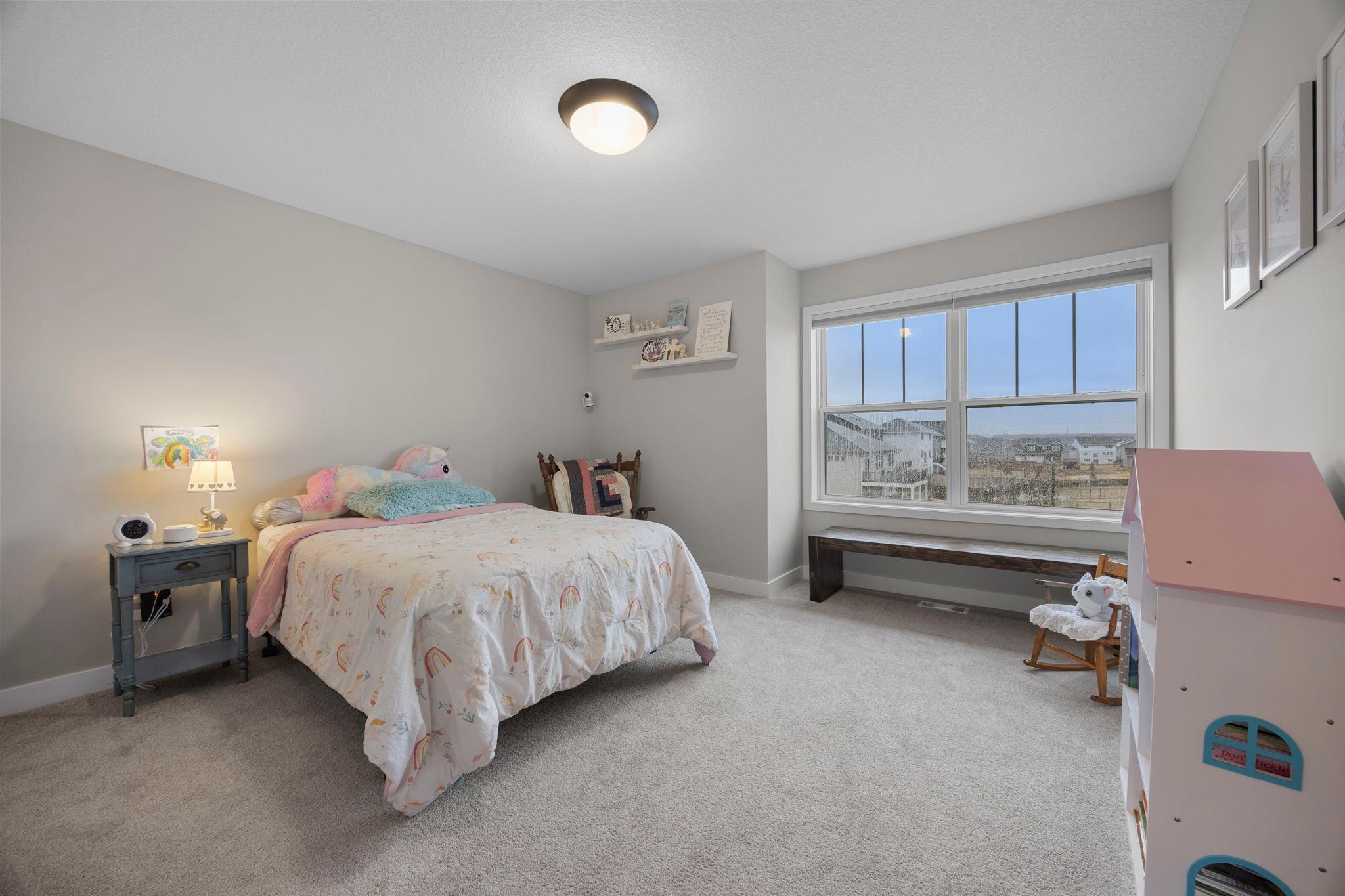 Upper level bedroom two features large windows and walk-in!