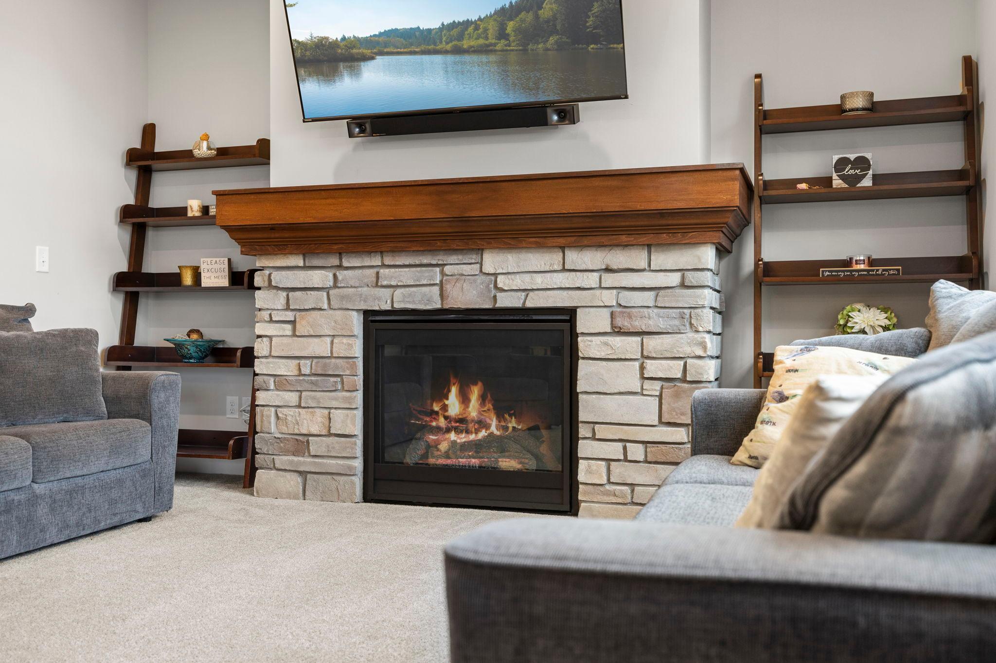 Cozy fireplace anchors the space and provides the perfect relaxation and entertaining area.