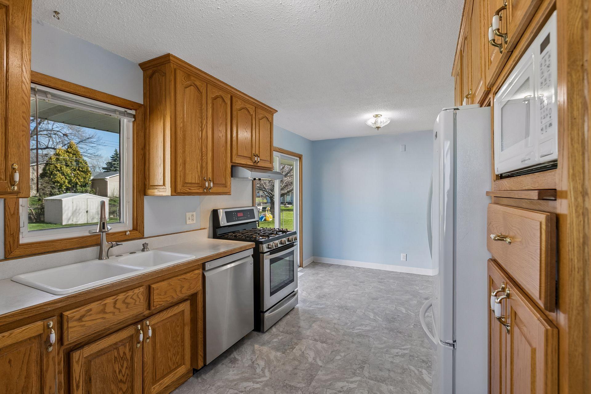 The window over the sink overlooks the backyard.