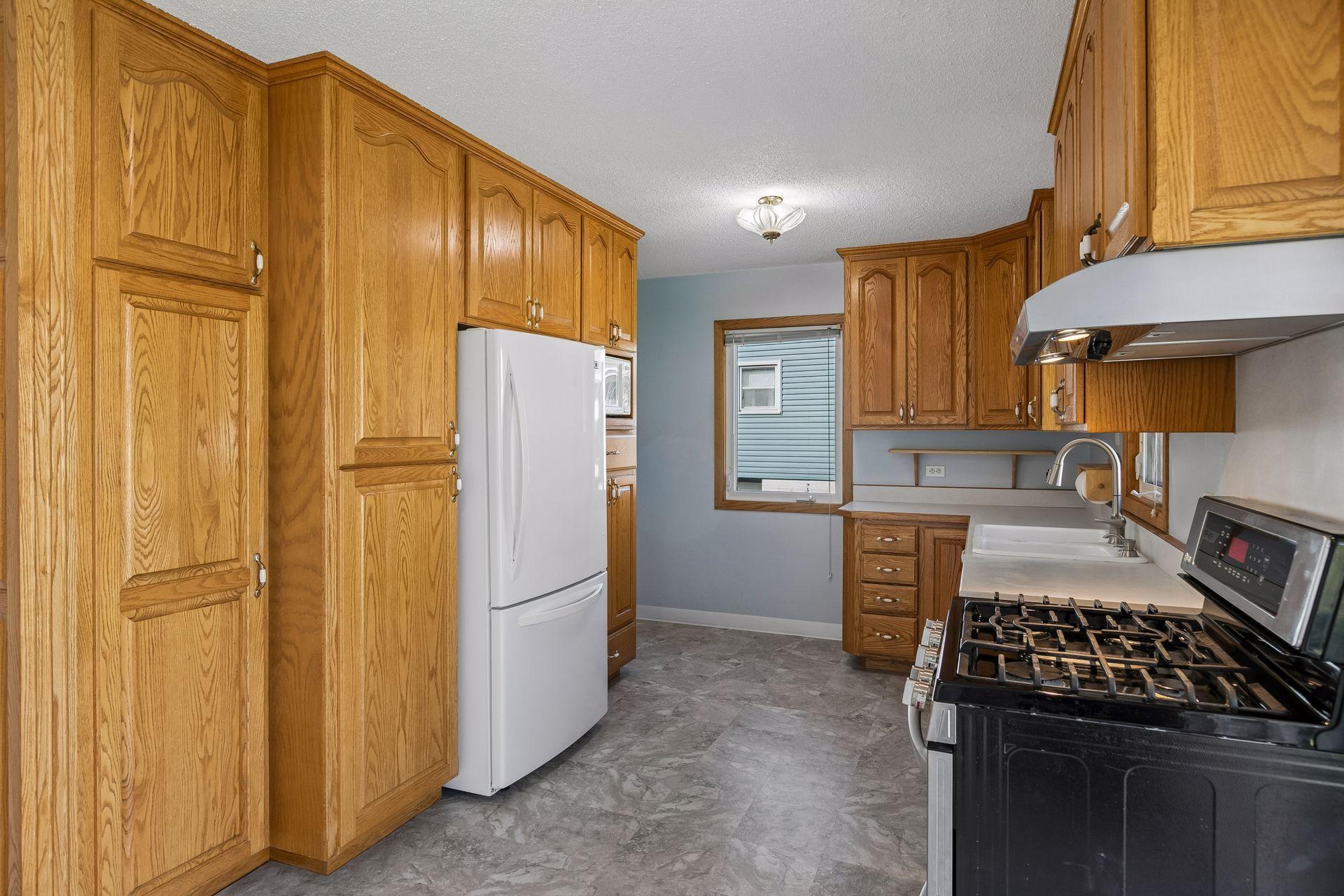 The kitchen is super functional with loads of cabinets.