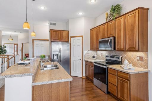 Cherry cabinetry, stainless steel appliances, quartz counters and timeless backsplash.