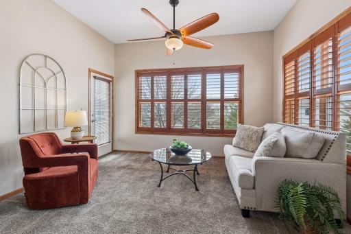 4 season porch is flooded with natural light and features beautiful custom plantation shutters, ceiling fan/light and access to your deck.