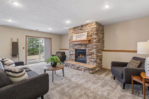 Stunning gas fireplace with raised hearth and hardwood mantel. Walk-out to private patio too.