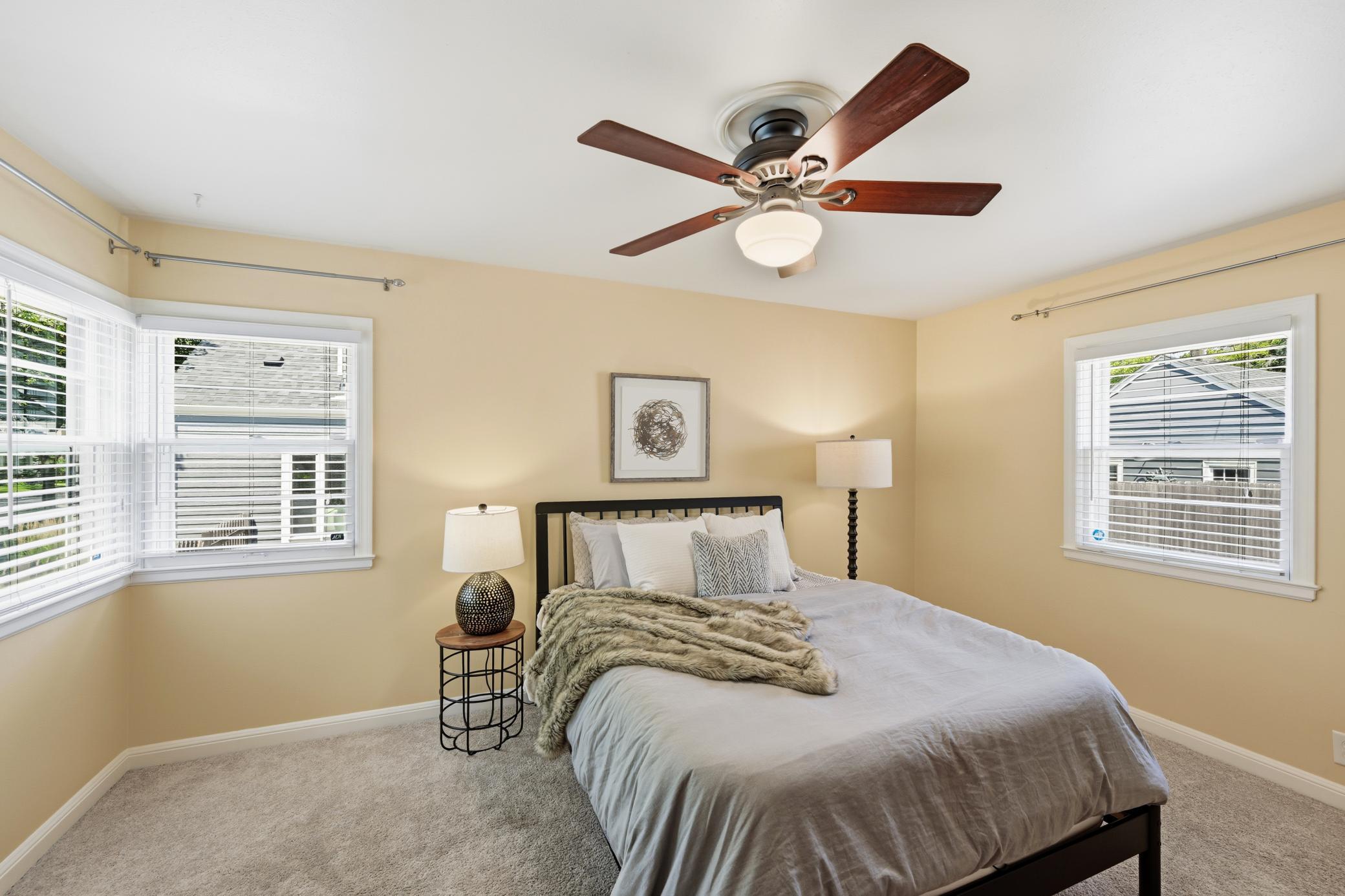 Primary bedroom has 2 closets and hardwood floors under carpet.
