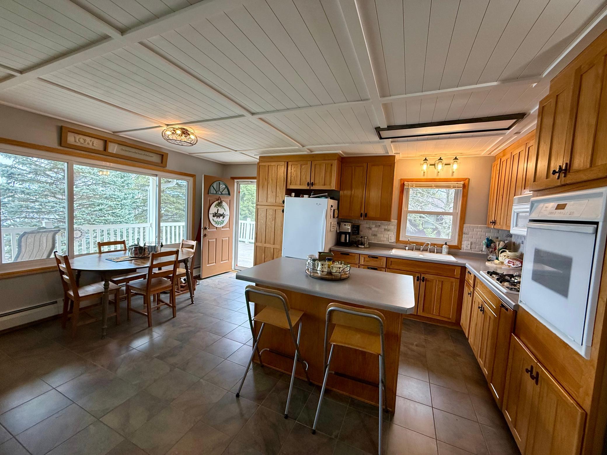 New backsplash and new ceiling adds a fresh touch, and abundant cabinetry offers great storage.
