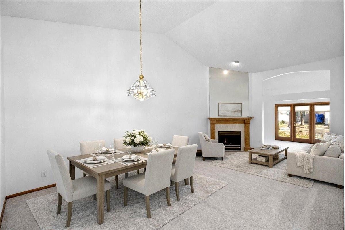 Open floor plan with vaulted ceiling at Dining Room and Living Room (virtually staged)