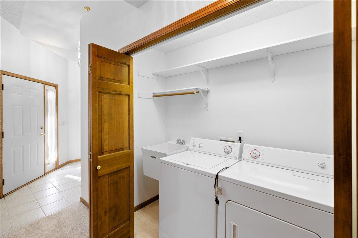 Convenient Laundry with Full size Washer and Dryer, utility sink, storage shelves