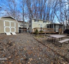 Park Model with Loft and MF Divider for "2nd bedroom" as well as quality sun room, deck, and additional storage shed. Two driveways provide ample parking.