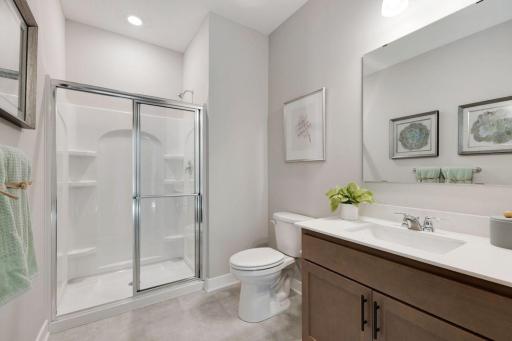 Main level 3/4 bathroom provides a place for the guest or main level resident to call their own. Photo of model home, colors and finishes may vary.