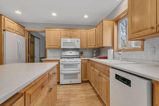 Easy Access from Garage - Tasteful Back Splash - Kitchen Window Overlooks the Private Backyard
