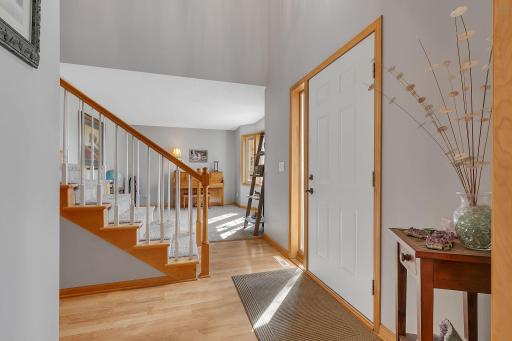 Sunlit Foyer Entry with Open Stairway Welcomes Guests