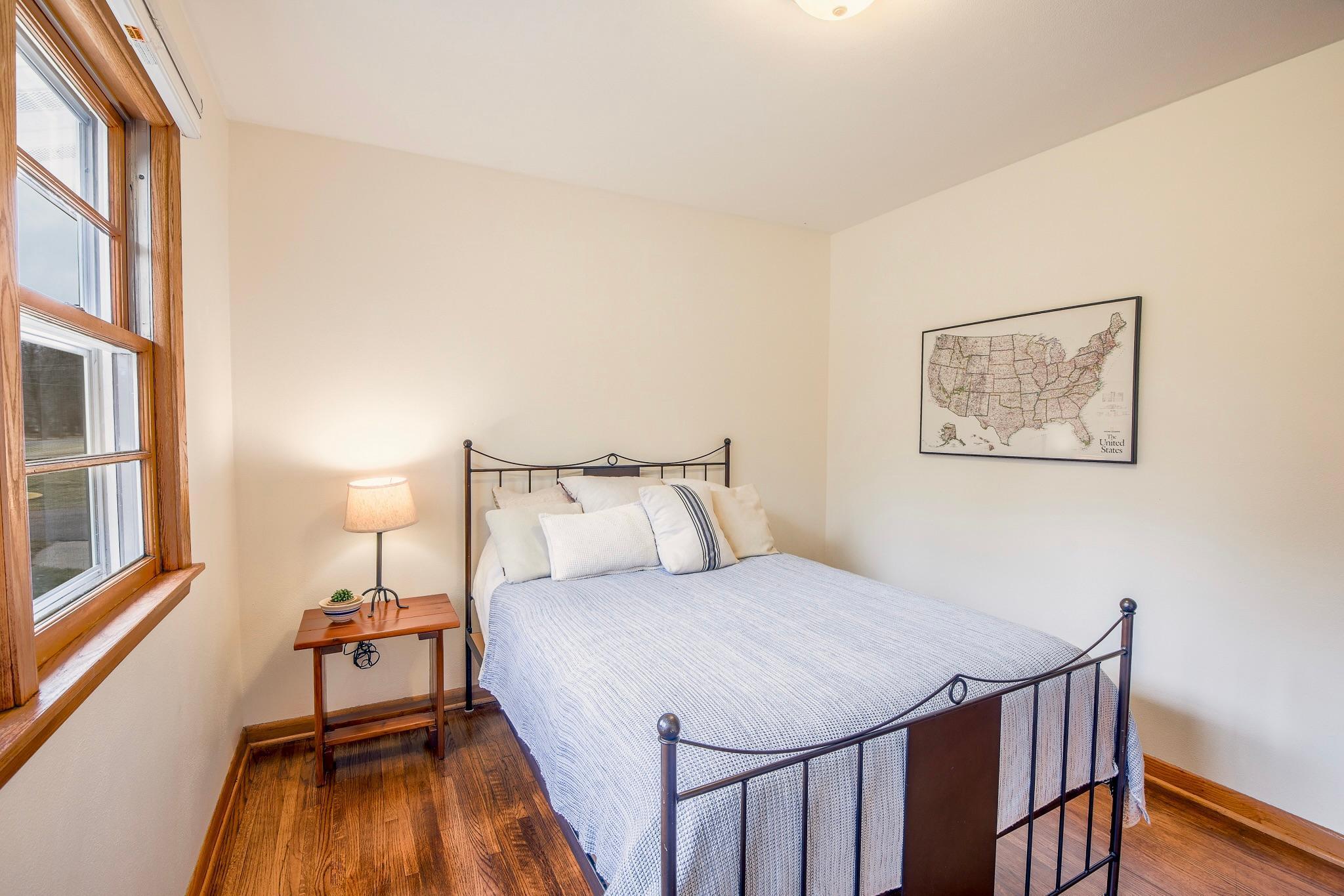 Bedroom retreat offers a serene space with natural light and a welcoming layout.