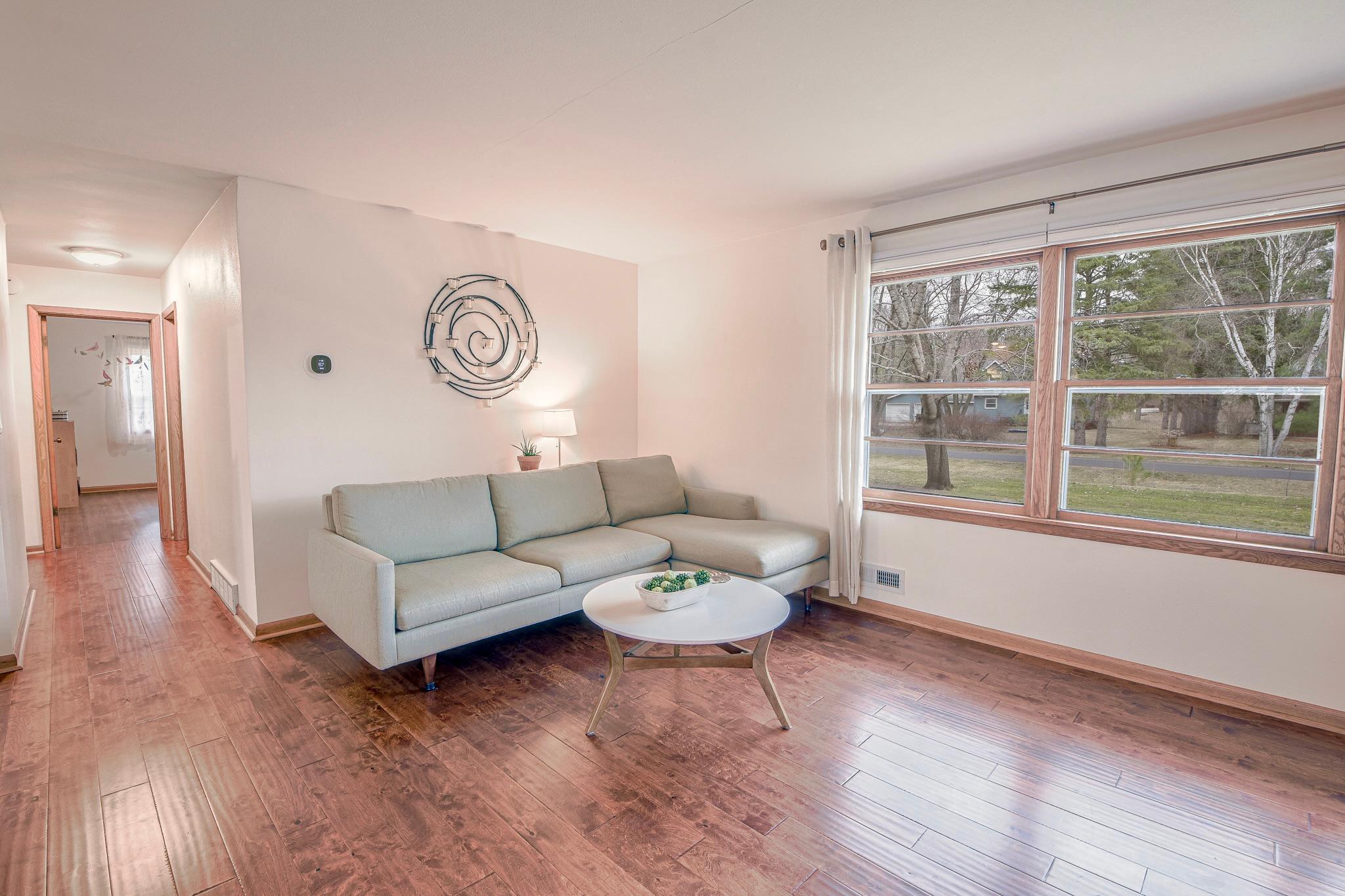 Front living room offers a bright and welcoming space upon entry.