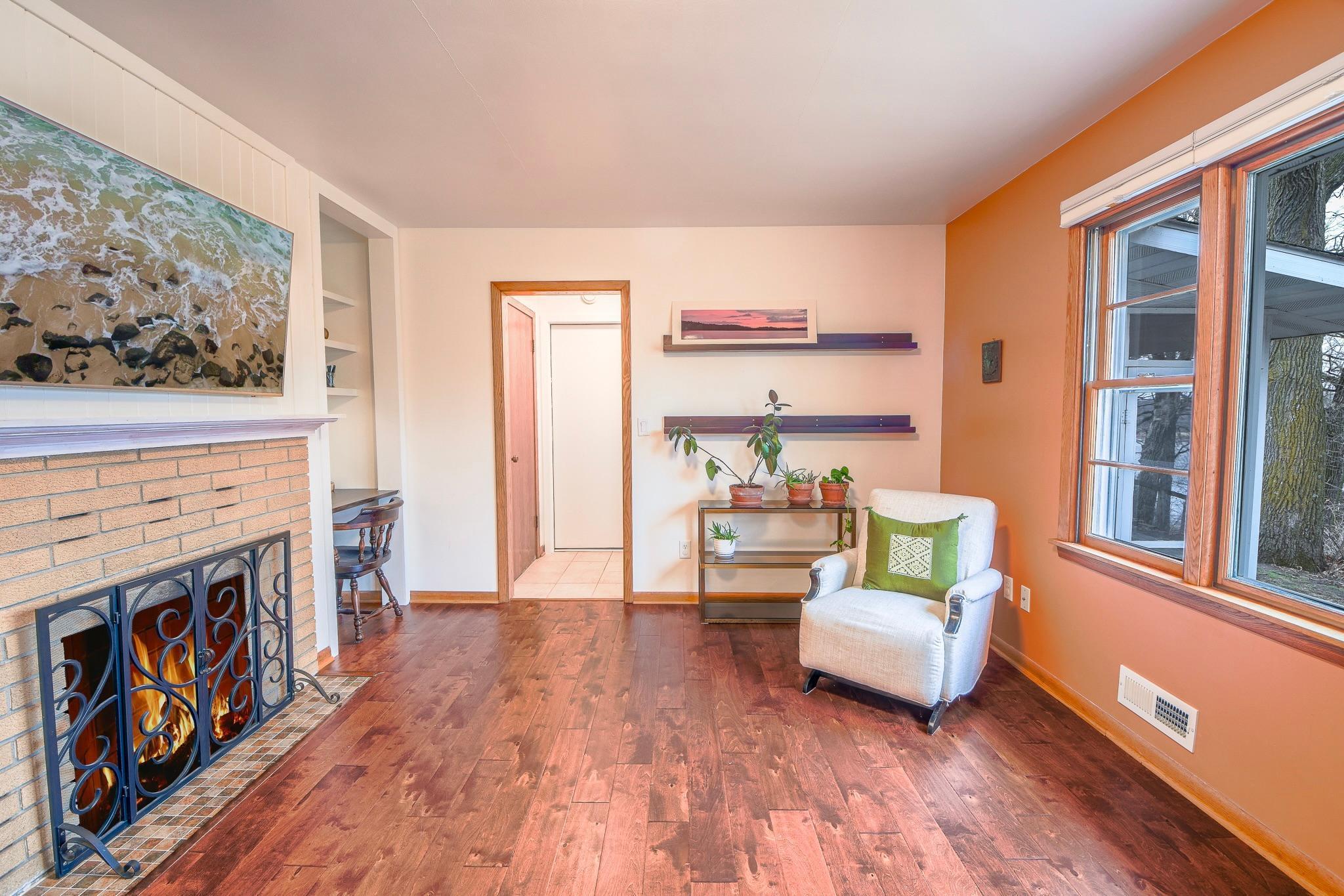 Adjacent to the kitchen, a versatile sitting space can serve as a dining area or reading nook.