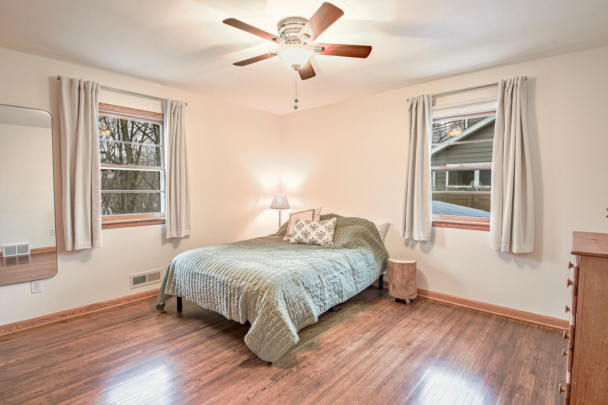 Spacious primary bedroom flooded with natural light.