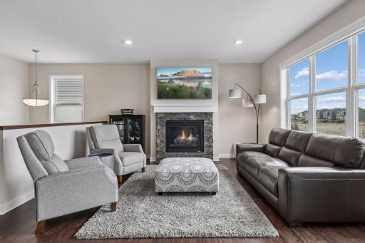 Living Room w/ Gas Fireplace and a Full Wall of Windows Overlooking the Pond - 2040 Diamond Lane