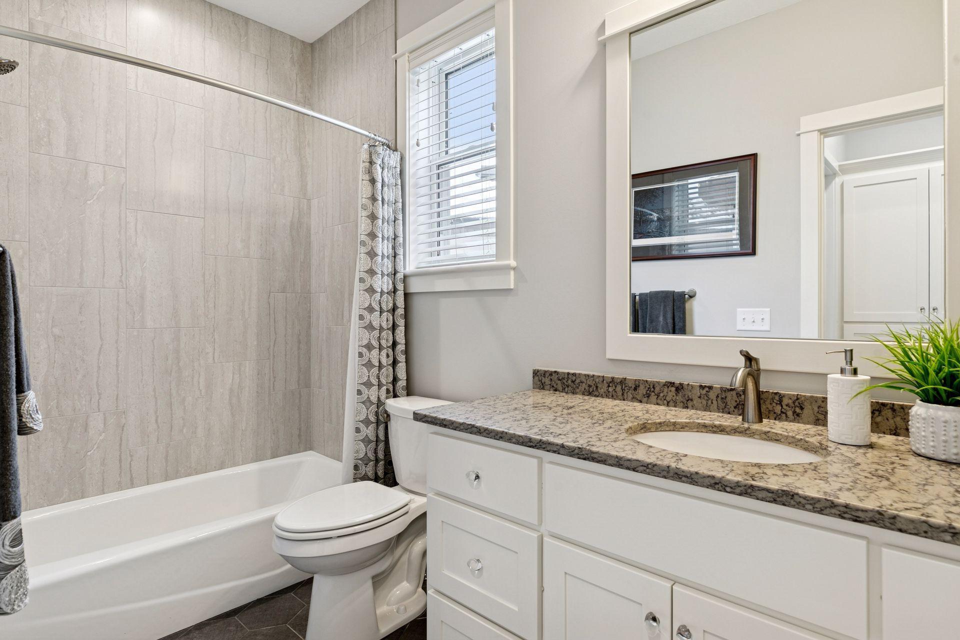 Main level full bath with tile up to the ceiling!