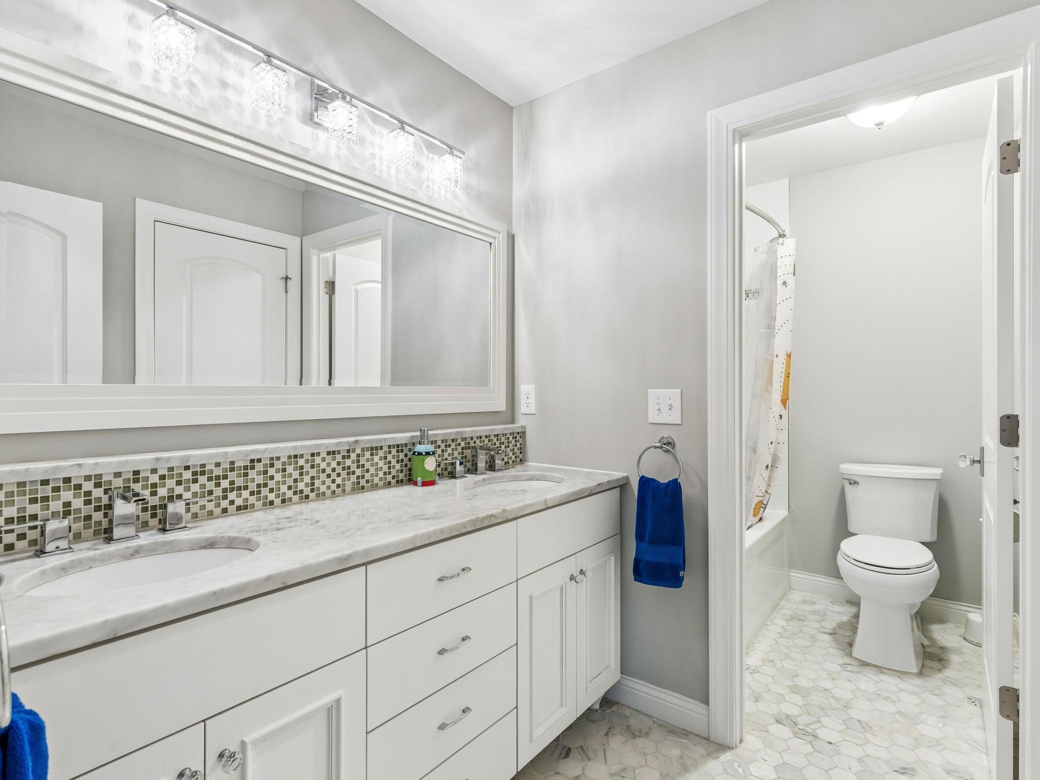 Jack and Jill bathroom with separate washroom and shower/tub combo