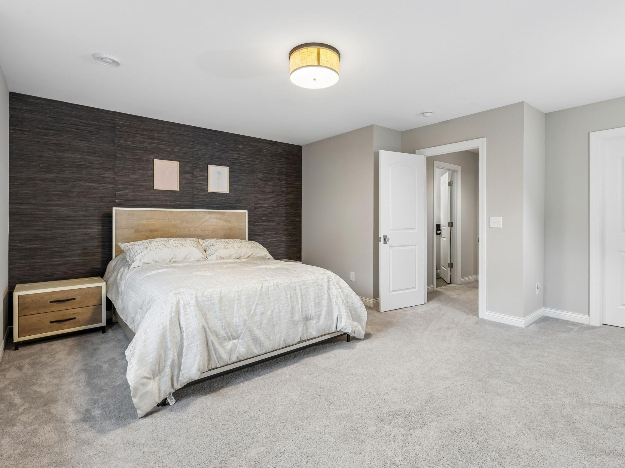 Lower level bedroom, the last bedrooms of five. Door leads back out to the family room and bathroom