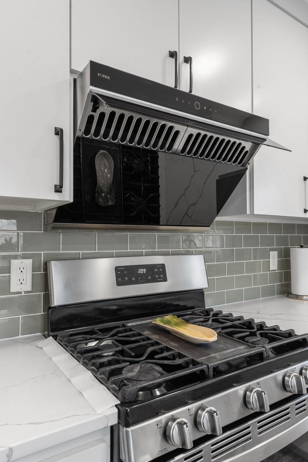 Photo shows hood in the open position. Just a wave of your hand across the hood will turn it off and close it.