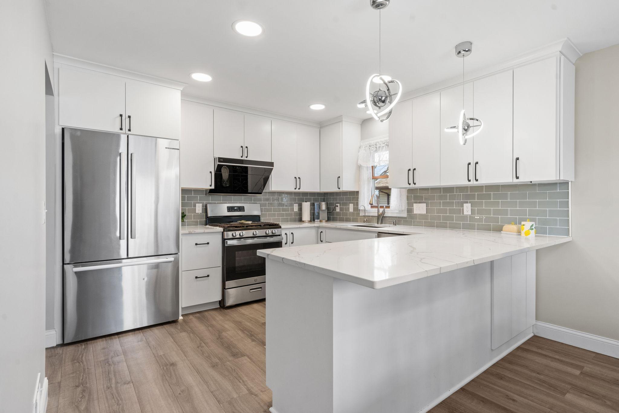 Quartz counters, new cabinets and backsplash, Bosch refrigerator and dishwasher.