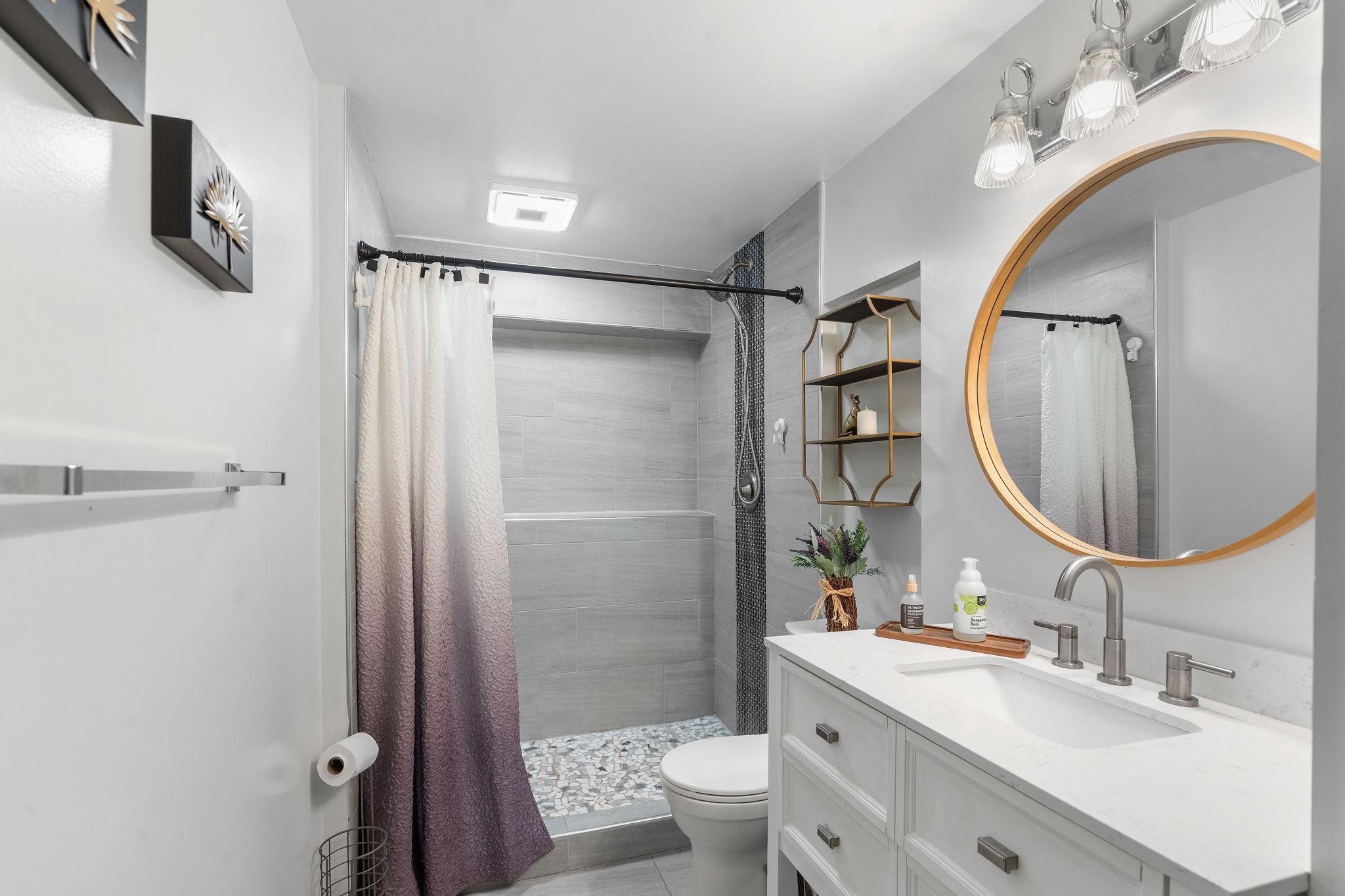 Updated shower with blue-tooth speaker feature as well as updated vanity.