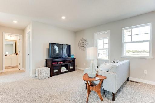 Upper level loft is a perfect space for watching tv, games, and gathering. Model photo. Options and colors will vary.