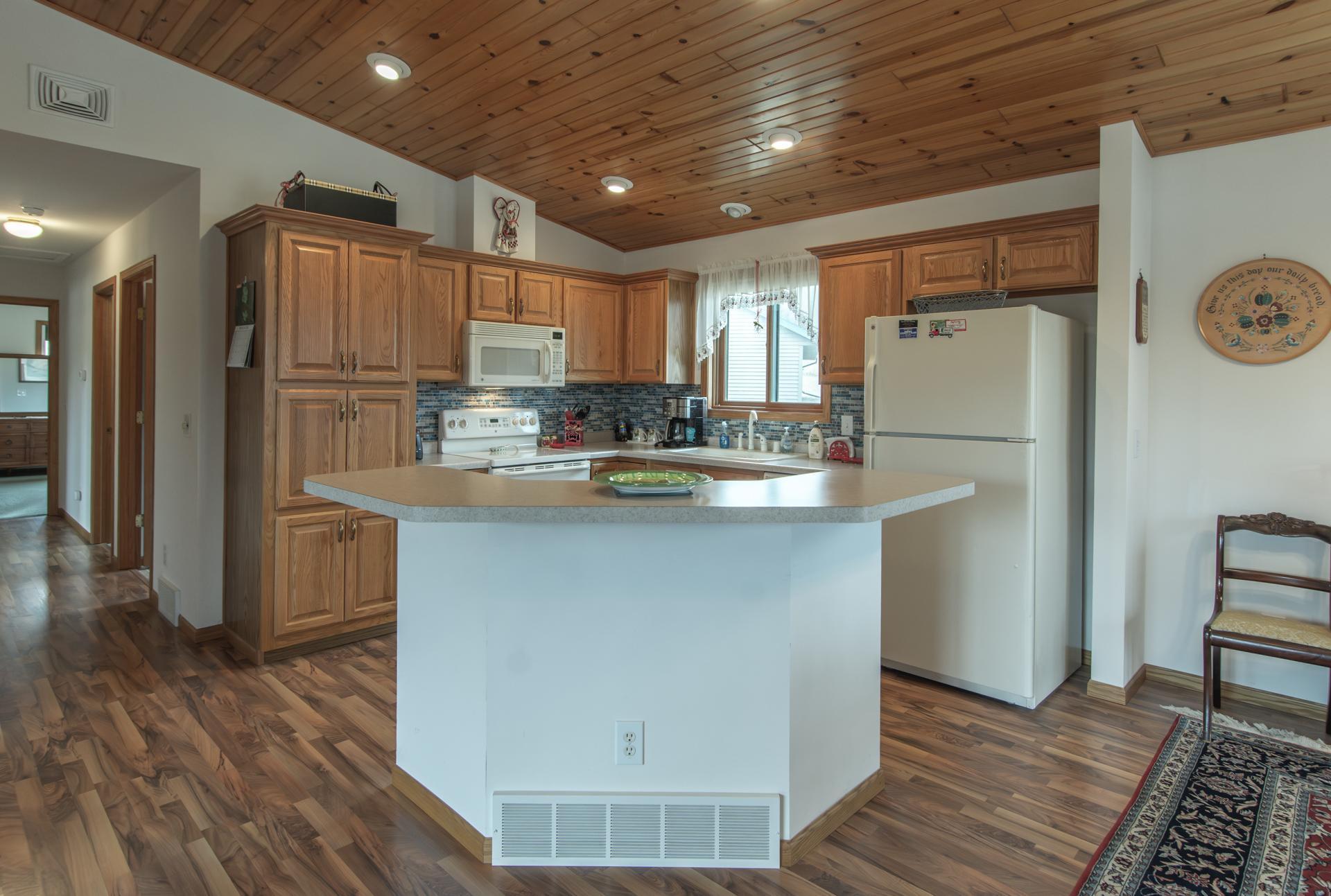 Bright kitchen flowing into the vaulted living room for an open, airy feel.