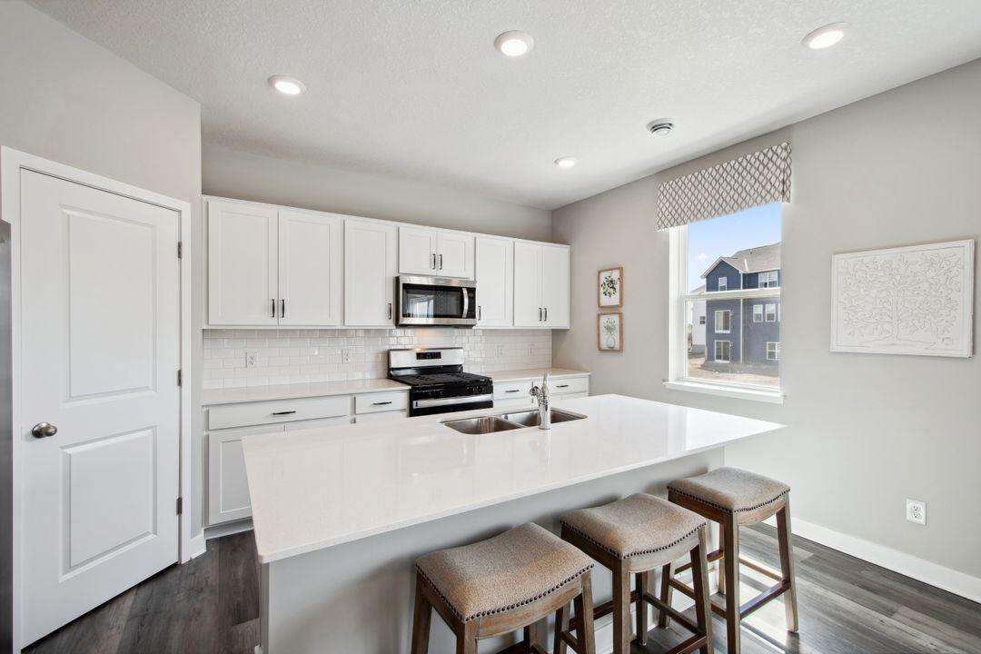 The gleaming quartz countertops is sleek and modern.