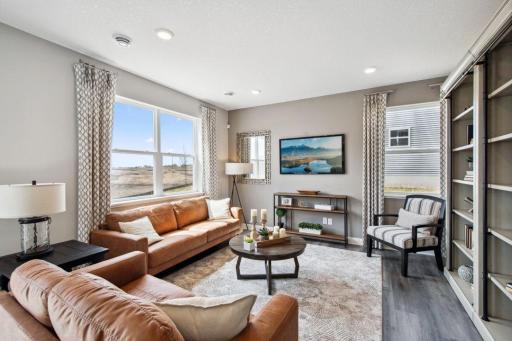 The living room is flooded with natural light due to the abundance of windows.