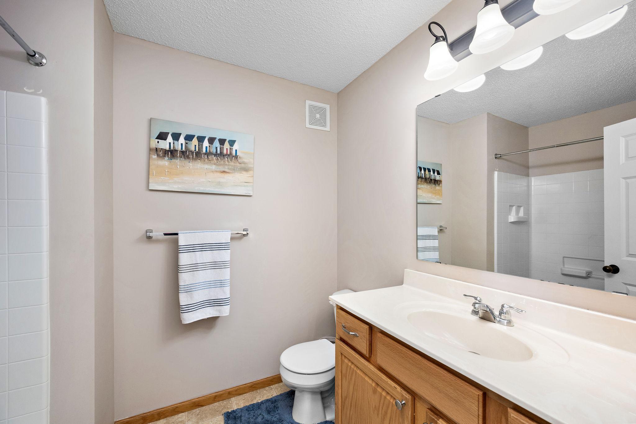 Upper level shared bathroom with tub and shower