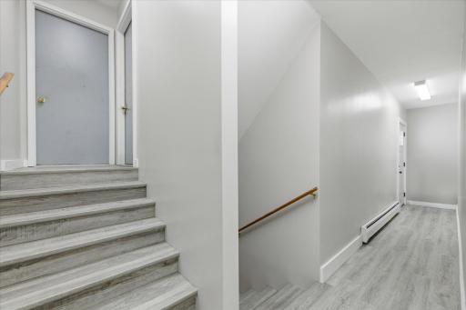 Back door entrance, near garage. Common area showing stairs to main floor units and LL unit and laundry.