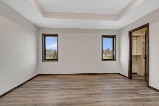 The primary bedroom is split to one side of the home