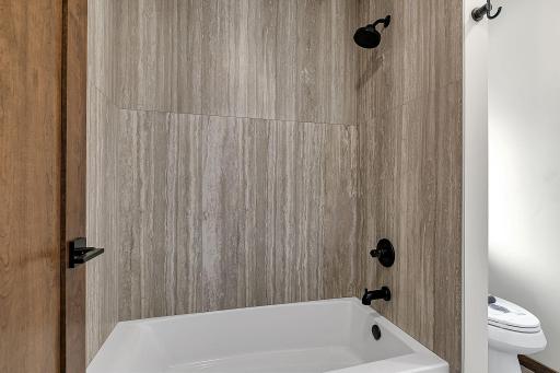 Huge 4 ft x 2 ft porcelain tile in the tub/shoer surround